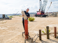 A technician inserts the bombs into the mortar for the preparation of the fireworks display at the New Port under construction in Molfetta,...