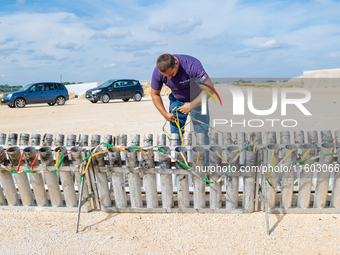 A technician inserts the bombs into the mortar for the preparation of the fireworks display at the New Port under construction in Molfetta,...