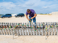 A technician inserts the bombs into the mortar for the preparation of the fireworks display at the New Port under construction in Molfetta,...