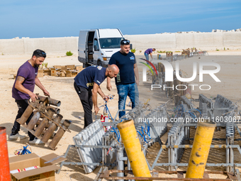 Technicians prepare the fireworks display at the New Port under construction in Molfetta, Italy, on September 22, 2024. On the final day of...