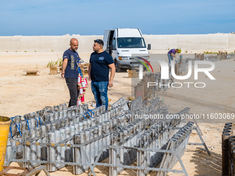 Technicians prepare the fireworks display at the New Port under construction in Molfetta, Italy, on September 22, 2024. On the final day of...