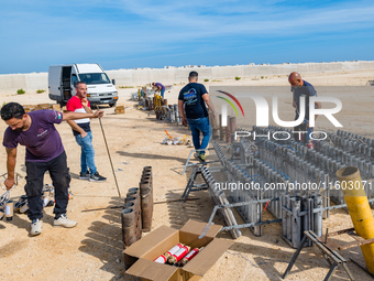 Technicians prepare the fireworks display at the New Port under construction in Molfetta, Italy, on September 22, 2024. On the final day of...