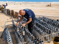 A technician inserts the bombs into the mortar for the preparation of the fireworks display at the New Port under construction in Molfetta,...