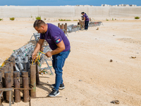 A technician inserts the bombs into the mortar for the preparation of the fireworks display at the New Port under construction in Molfetta,...