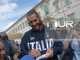 Gianmarco Tamberi signs autographs at the end of the flag ceremony with the President of the Republic Sergio Mattarella in Rome, Italy, on S...