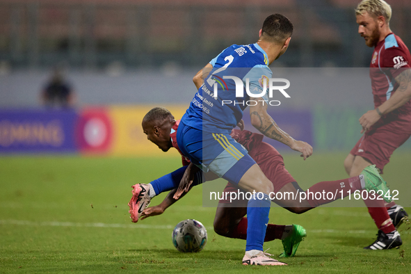 Alex Da Paixao Alves (back) of Gzira United is challenged by Jean Borg (front) of Sliema Wanderers during the Malta 360 Sports Premier Leagu...