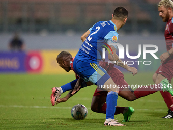 Alex Da Paixao Alves (back) of Gzira United is challenged by Jean Borg (front) of Sliema Wanderers during the Malta 360 Sports Premier Leagu...