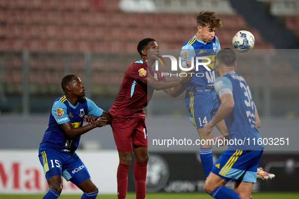 Nicholas Strickland (top 2nd right) heads the ball during the Malta 360 Sports Premier League soccer match between Gzira United and Sliema W...