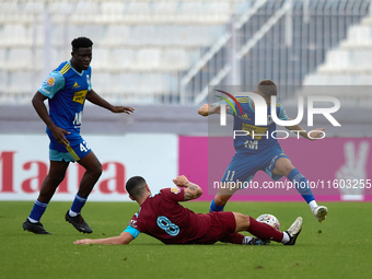 In Ta' Qali, Malta, on September 21, 2024, Zachary Scerri (center) of Gzira United competes for the ball with Myles Beerman (right) of Sliem...