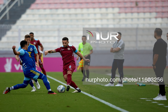 Zachary Scerri (C) of Gzira United is in action during the Malta 360 Sports Premier League soccer match between Gzira United and Sliema Wand...