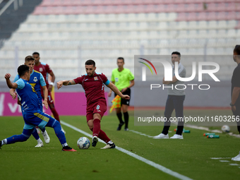 Zachary Scerri (C) of Gzira United is in action during the Malta 360 Sports Premier League soccer match between Gzira United and Sliema Wand...