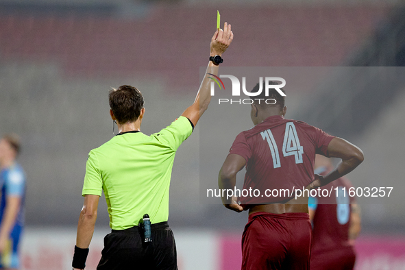 In Ta' Qali, Malta, on September 21, 2024, Malta FA-appointed match referee Alex Johnson (L) shows the yellow card to Luis Carlo Riascos (R)...