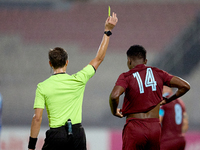 In Ta' Qali, Malta, on September 21, 2024, Malta FA-appointed match referee Alex Johnson (L) shows the yellow card to Luis Carlo Riascos (R)...