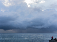 Fishermen and some passers-by are surprised by the unstable autumn weather on the Barcelona coast, in Barcelona, Spain, on September 23, 202...