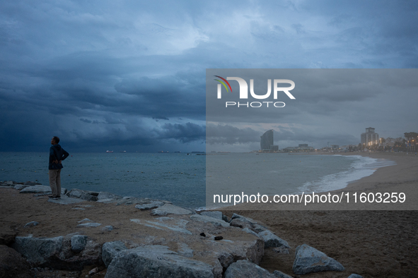 Fishermen and some passers-by are surprised by the unstable autumn weather on the Barcelona coast, in Barcelona, Spain, on September 23, 202...