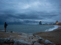 Fishermen and some passers-by are surprised by the unstable autumn weather on the Barcelona coast, in Barcelona, Spain, on September 23, 202...