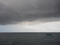 Fishermen and some passers-by are surprised by the unstable autumn weather on the Barcelona coast, in Barcelona, Spain, on September 23, 202...