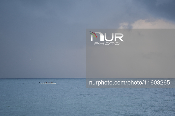 Fishermen and some passers-by are surprised by the unstable autumn weather on the Barcelona coast, in Barcelona, Spain, on September 23, 202...