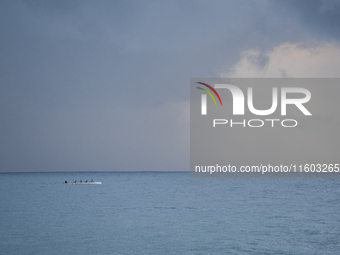 Fishermen and some passers-by are surprised by the unstable autumn weather on the Barcelona coast, in Barcelona, Spain, on September 23, 202...