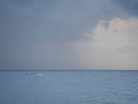 Fishermen and some passers-by are surprised by the unstable autumn weather on the Barcelona coast, in Barcelona, Spain, on September 23, 202...