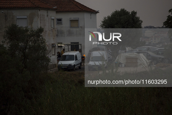 People cook with fire in cloudy weather due to smoke from wildfires in Lisbon, Portugal, on September 22, 2024. The fires that begin on Sept...