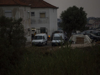 People cook with fire in cloudy weather due to smoke from wildfires in Lisbon, Portugal, on September 22, 2024. The fires that begin on Sept...