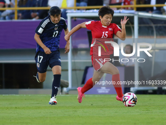 Uno Shiragaki of Japan and Il-Son Choe of Korea DPR fight for the ball during the FIFA U-20 Women's World Cup final match between Korea DPR...