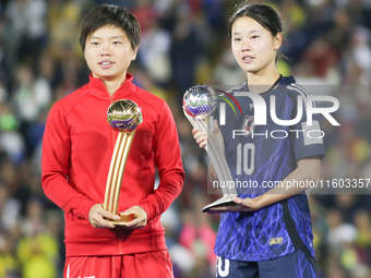 Choe Il Son of Korea DPR poses with the Adidas Golden Ball award and Manaka Matsukubo of Japan poses with the Adidas Silver Ball Award after...