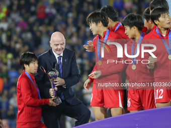 Gianni Infantino gives the trophy to the Korea DPR players during the FIFA U-20 Women's World Cup Colombia 2024 final match between Korea DP...