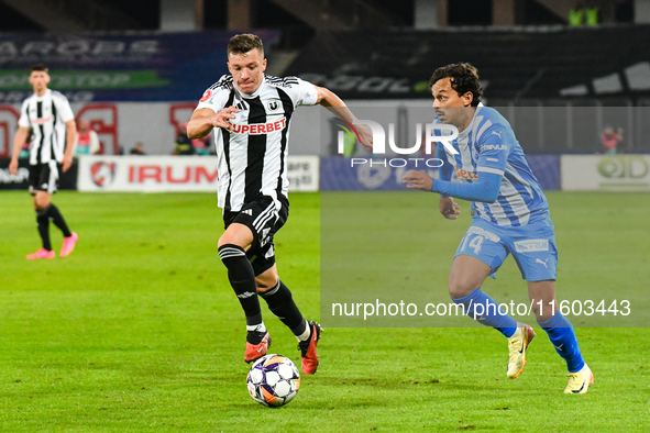 Lyes Hafid Houri and Vadim Rata are in action during the match between Universitatea Cluj and Universitatea Craiova at Cluj Arena Stadium in...