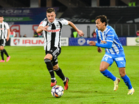 Lyes Hafid Houri and Vadim Rata are in action during the match between Universitatea Cluj and Universitatea Craiova at Cluj Arena Stadium in...