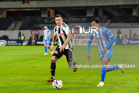 Lyes Hafid Houri and Vadim Rata are in action during the match between Universitatea Cluj and Universitatea Craiova at Cluj Arena Stadium in...