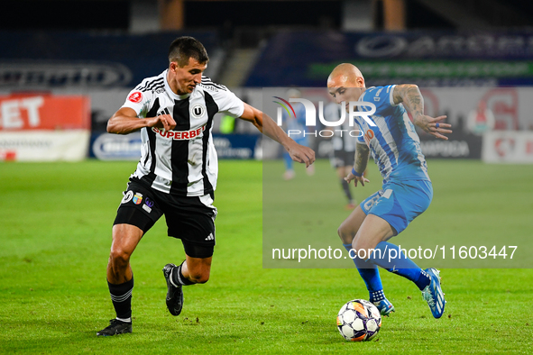 Ionut Alexandru Mitrita and Lucas Gabriel Masoero are in action during the match between Universitatea Cluj and Universitatea Craiova at Clu...