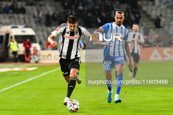 Stefan Baiaram and Lucian Iulian Cristea are in action during the match between Universitatea Cluj and Universitatea Craiova at Cluj Arena S...