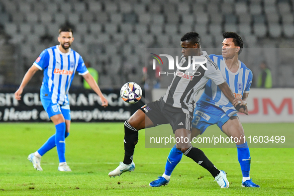 Mamadou Thiam and Denil Omar Maldonado Munguia are in action during the match between Universitatea Cluj and Universitatea Craiova at Cluj A...