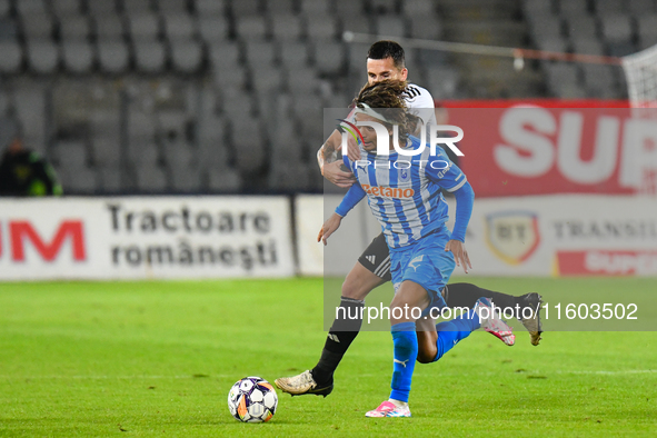 Takuto Oshima and Ovidiu Alexandru Bic are in action during the match between Universitatea Cluj and Universitatea Craiova at Cluj Arena Sta...