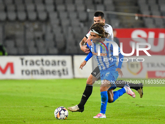 Takuto Oshima and Ovidiu Alexandru Bic are in action during the match between Universitatea Cluj and Universitatea Craiova at Cluj Arena Sta...