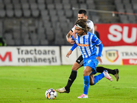 Takuto Oshima and Ovidiu Alexandru Bic are in action during the match between Universitatea Cluj and Universitatea Craiova at Cluj Arena Sta...