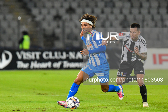 Takuto Oshima and Ovidiu Alexandru Bic are in action during the match between Universitatea Cluj and Universitatea Craiova at Cluj Arena Sta...