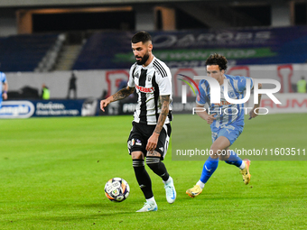 Radu Stefanita Boboc and Luis Javier Paradela Diaz are in action during the match between Universitatea Cluj and Universitatea Craiova at Cl...