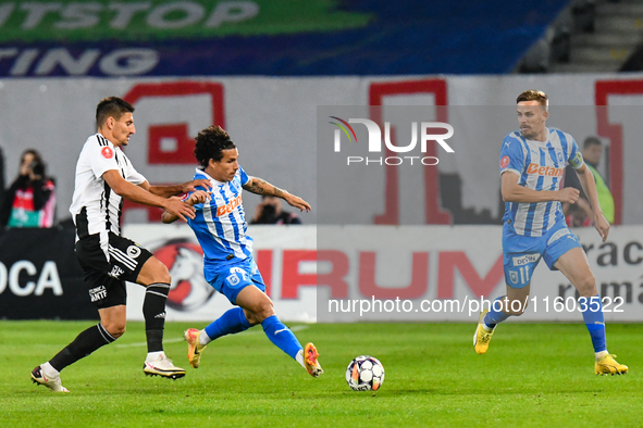 Luis Javier Paradela Diaz and Lucian Iulian Cristea are in action during the match between Universitatea Cluj and Universitatea Craiova at C...