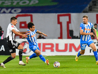 Luis Javier Paradela Diaz and Lucian Iulian Cristea are in action during the match between Universitatea Cluj and Universitatea Craiova at C...