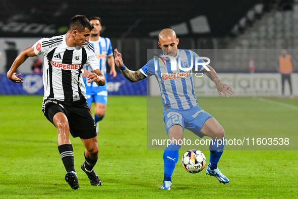 Ionut Alexandru Mitrita and Lucas Gabriel Masoero are in action during the match between Universitatea Cluj and Universitatea Craiova at Clu...