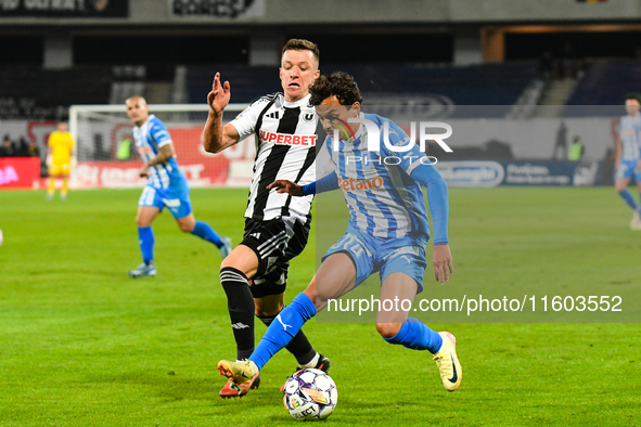 Lyes Hafid Houri and Vadim Rata are in action during the match between Universitatea Cluj and Universitatea Craiova at Cluj Arena Stadium in...