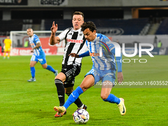 Lyes Hafid Houri and Vadim Rata are in action during the match between Universitatea Cluj and Universitatea Craiova at Cluj Arena Stadium in...