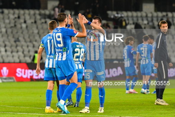 Nicusor Silviu Bancu, Juraj Badelj, and Elvir Koljic participate in the match between Universitatea Cluj and Universitatea Craiova in Cluj,...