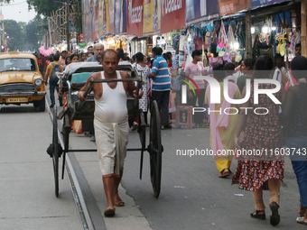 Hand-pulled rickshaw pullers in Kolkata, India, wait for customers on September 21, 2024. (