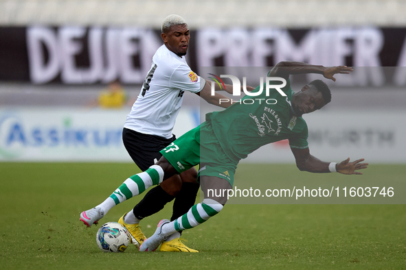 In Ta' Qali, Malta, on September 22, 2024, Franklin Sasere of Floriana is challenged from the back by Nunes Silva Pedro Henrique of Hibernia...