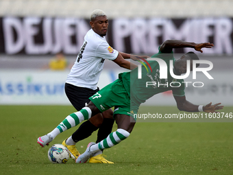 In Ta' Qali, Malta, on September 22, 2024, Franklin Sasere of Floriana is challenged from the back by Nunes Silva Pedro Henrique of Hibernia...