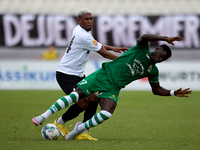 In Ta' Qali, Malta, on September 22, 2024, Franklin Sasere of Floriana is challenged from the back by Nunes Silva Pedro Henrique of Hibernia...